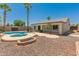 Backyard includes a pool, gravel landscaping and a fire pit at 7924 W Hammond Ln, Phoenix, AZ 85043