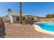 Backyard featuring a beautiful pool, palm trees, desert landscaping and patio at 7924 W Hammond Ln, Phoenix, AZ 85043