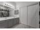 Stylish bathroom features double sinks, modern lighting, and ample storage with a large mirror and white cabinets at 7924 W Hammond Ln, Phoenix, AZ 85043