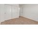 Carpeted bedroom includes closet with double doors and neutral walls at 7924 W Hammond Ln, Phoenix, AZ 85043