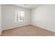 This carpeted bedroom is illuminated by a window offering lots of natural light at 7924 W Hammond Ln, Phoenix, AZ 85043