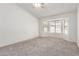 This carpeted bedroom is brightly lit with a scenic view out of the bay window at 7924 W Hammond Ln, Phoenix, AZ 85043