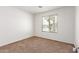 Carpeted bedroom is brightly lit with a scenic view out of the window at 7924 W Hammond Ln, Phoenix, AZ 85043