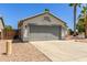 Attached single-story home with a gray two-car garage and desert landscaping at 7924 W Hammond Ln, Phoenix, AZ 85043