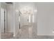 Bright hallway with white walls, a chandelier, and doors leading to other rooms at 7924 W Hammond Ln, Phoenix, AZ 85043