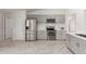 Spacious kitchen with gray cabinets, stainless steel appliances, and white countertops at 7924 W Hammond Ln, Phoenix, AZ 85043