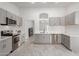Modern kitchen featuring gray cabinets, stainless steel appliances, and an open layout at 7924 W Hammond Ln, Phoenix, AZ 85043