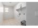 Bright laundry room with tile floors, window, and utility sink hook-ups at 7924 W Hammond Ln, Phoenix, AZ 85043