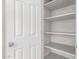 White pantry with patterned shelf lining provides ample storage space with multiple shelves for organization at 7924 W Hammond Ln, Phoenix, AZ 85043