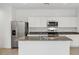 Well-lit kitchen with stainless steel appliances and a granite countertop island at 8474 W Clemente Way, Florence, AZ 85132