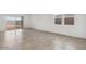 Bright living room with tile floor, sliding glass doors, and large windows at 8474 W Clemente Way, Florence, AZ 85132