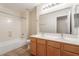 Bright bathroom with double sink vanity and a shower-tub combo at 10226 E Pine Valley Rd, Scottsdale, AZ 85255