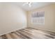 Cozy bedroom with wood floors and a large window at 10226 E Pine Valley Rd, Scottsdale, AZ 85255