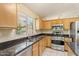 Well-lit kitchen features granite countertops and stainless steel appliances at 10226 E Pine Valley Rd, Scottsdale, AZ 85255