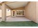 Covered patio with door and window overlooking artificial grass patch at 10226 E Pine Valley Rd, Scottsdale, AZ 85255