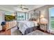 Comfortable bedroom featuring a golf course view, ceiling fan and decorative metal headboard at 10643 W Pineaire W Dr, Sun City, AZ 85351