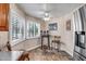 Bright breakfast nook featuring white shutters, wood-look floors, a ceiling fan, and comfortable seating at 10643 W Pineaire W Dr, Sun City, AZ 85351