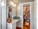 Well-organized walk-in closet and vanity with mirrored wall, offering ample storage space at 10643 W Pineaire W Dr, Sun City, AZ 85351