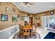 Warm and inviting dining room with a wooden table, decorative rug, and golf course artwork at 10643 W Pineaire W Dr, Sun City, AZ 85351