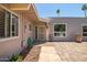 Welcoming front porch showcasing stylish pavers, desert landscaping, and a secured decorative front door at 10643 W Pineaire W Dr, Sun City, AZ 85351