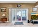 Spacious living area leading to bright sunroom with tiled flooring and large glass windows at 10643 W Pineaire W Dr, Sun City, AZ 85351