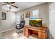 Functional office with parquet floors, a large desk, comfortable chair and natural light at 10643 W Pineaire W Dr, Sun City, AZ 85351
