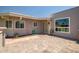 Inviting backyard patio featuring pavers and a charming entrance with stylish details at 10643 W Pineaire W Dr, Sun City, AZ 85351