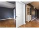 Bedroom with wood floors, dark grey walls, and built-in storage at 11026 N 28Th Dr # 34, Phoenix, AZ 85029