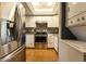 Updated kitchen features stainless steel appliances, stylish backsplash, granite countertops, and laminate flooring at 11026 N 28Th Dr # 34, Phoenix, AZ 85029