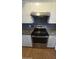 Updated kitchen featuring stainless steel appliances, white cabinets with gold hardware, and laminate flooring at 11026 N 28Th Dr # 34, Phoenix, AZ 85029