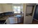 This kitchen features granite countertops, white cabinets, stainless steel appliances, and a washer/dryer combo at 11026 N 28Th Dr # 34, Phoenix, AZ 85029