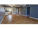 A spacious living room with laminate flooring, built-in shelves, and a view of the kitchen at 11026 N 28Th Dr # 34, Phoenix, AZ 85029