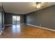 A spacious living room with laminate flooring, a ceiling fan, and sliding glass doors to the balcony at 11026 N 28Th Dr # 34, Phoenix, AZ 85029