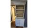 Built in storage cabinet with shelving next to a doorway and laminate wood-look flooring at 11026 N 28Th Dr # 34, Phoenix, AZ 85029