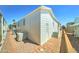 A bright, white home exterior featuring a brick walkway, and an air conditioning unit at 111 S Greenfield Rd # 467, Mesa, AZ 85206