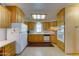 Well-lit kitchen featuring plentiful oak cabinetry and modern white appliances at 111 S Greenfield Rd # 467, Mesa, AZ 85206