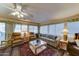 Cozy living room with two recliners, a sofa, a ceiling fan, and large windows at 111 S Greenfield Rd # 467, Mesa, AZ 85206