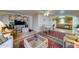 Bright living room with display shelving, a ceiling fan, and views into the kitchen at 111 S Greenfield Rd # 467, Mesa, AZ 85206