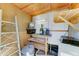 Organized shed interior with shelving, ladder, storage containers, and lighting for functionality at 111 S Greenfield Rd # 467, Mesa, AZ 85206