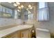 Cozy bathroom with a vanity, toilet, and mirror, showcasing functionality and classic design elements at 111 S Greenfield Rd # 531, Mesa, AZ 85206