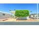Charming mobile home with a mature shade tree in the front yard, covered parking, and landscaping at 111 S Greenfield Rd # 531, Mesa, AZ 85206