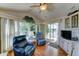 Bright living room with lots of windows, chairs, and a sliding door to the outside at 111 S Greenfield Rd # 531, Mesa, AZ 85206