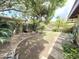 Expansive yard with mature trees, manicured landscape, and brick trim at 1118 E Orangewood Ave, Phoenix, AZ 85020
