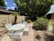 Backyard patio area features outdoor dining, lush landscaping, and a peaceful ambiance at 1118 E Orangewood Ave, Phoenix, AZ 85020
