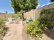Backyard patio area features outdoor dining, manicured landscaping, and a serene water feature at 1118 E Orangewood Ave, Phoenix, AZ 85020