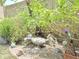 Quaint backyard with rock features, privacy wall, and lush shrubs at 1118 E Orangewood Ave, Phoenix, AZ 85020