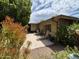 Backyard patio with lounge chairs, mature landscaping, and a relaxing outdoor space at 1118 E Orangewood Ave, Phoenix, AZ 85020