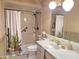 Bathroom includes a single sink vanity, toilet, and shower-tub combination with unique cactus-themed shower curtain at 1118 E Orangewood Ave, Phoenix, AZ 85020