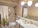 Bathroom includes a single sink vanity, toilet, and shower-tub combination with unique cactus-themed shower curtain at 1118 E Orangewood Ave, Phoenix, AZ 85020