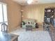 Bedroom featuring light colored carpet, wood paneled walls, and checkered sofa at 1118 E Orangewood Ave, Phoenix, AZ 85020